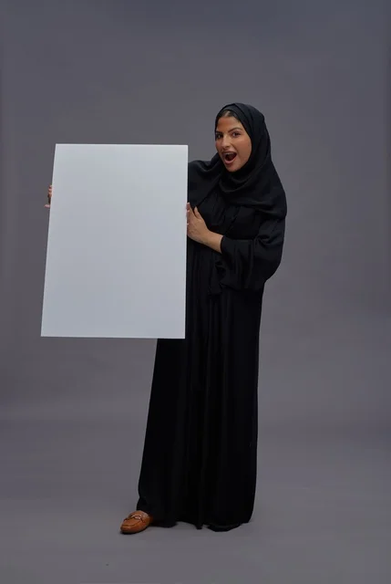 Saudi Woman in Abaya Holding Blank White Board
