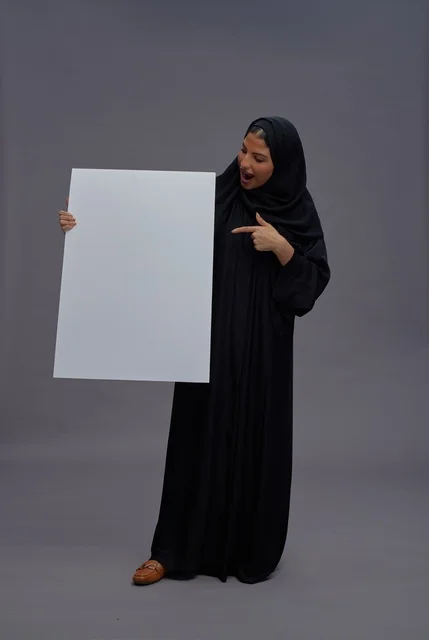 Saudi Woman in Abaya Holding Blank Board