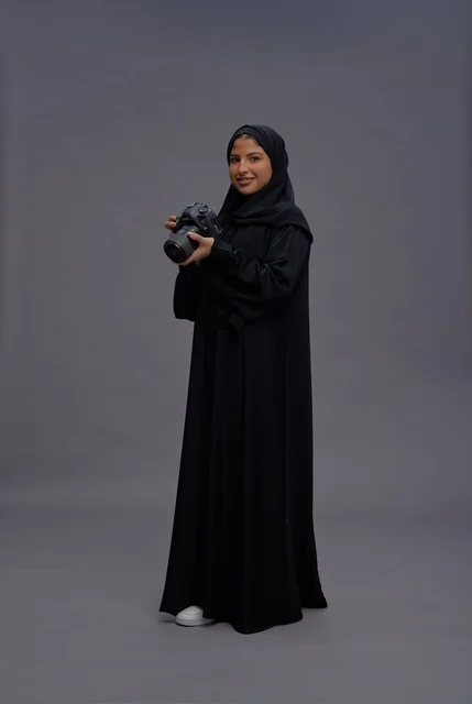 Saudi Woman in Abaya Holding Professional Camera
