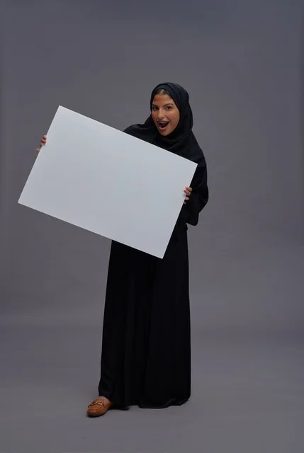 Saudi Woman in Abaya Holding Blank White Placard