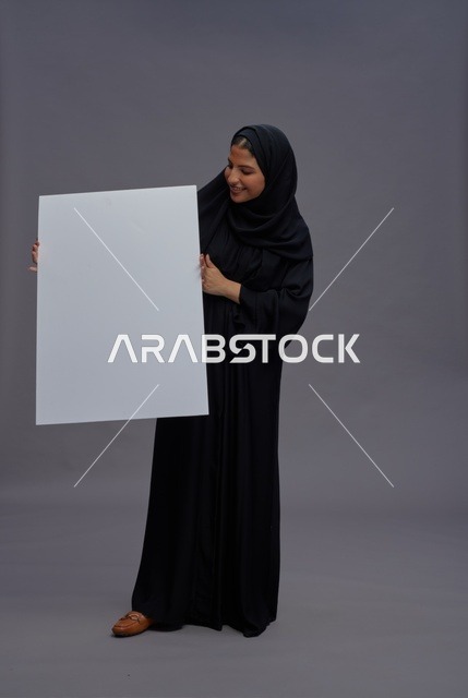 Saudi Woman in Black Abaya Holding Blank White Board
