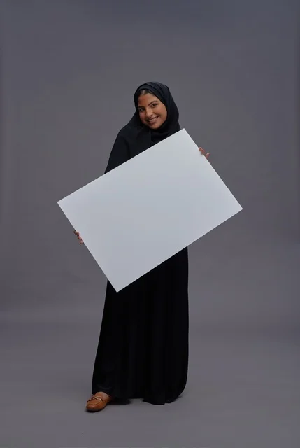 Saudi Woman in Abaya Holding Blank White Board