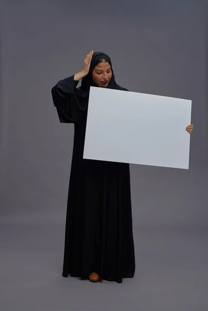 Saudi Woman in Abaya Holding Blank White Sign Board
