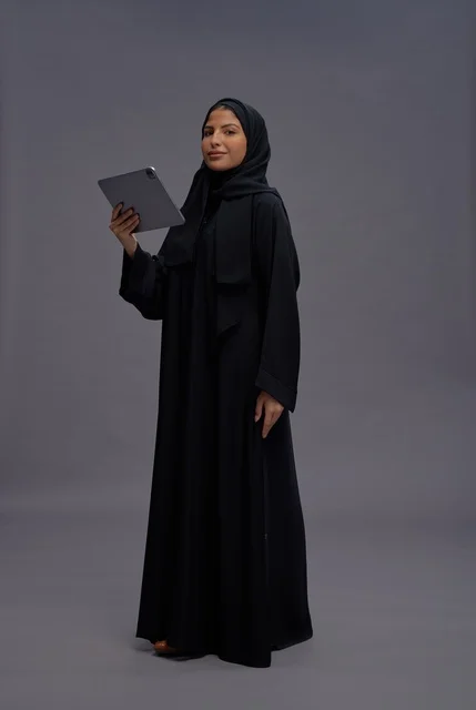 Saudi Woman in Black Abaya Holding Tablet in Studio