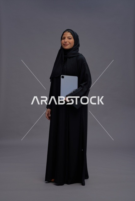 Saudi Woman with Digital Tablet on Grey Background