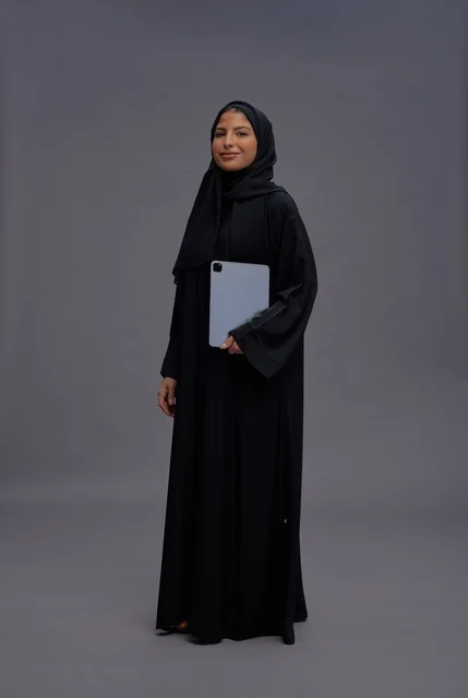 Saudi Woman with Digital Tablet on Grey Background