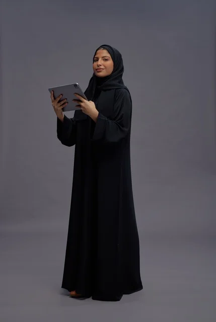 Saudi Woman in Black Abaya Using Tablet Studio Portrait