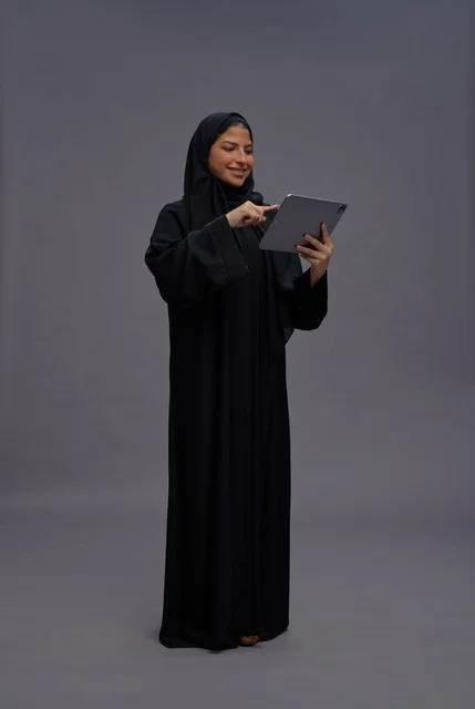 Saudi Woman in Black Abaya Using Digital Tablet