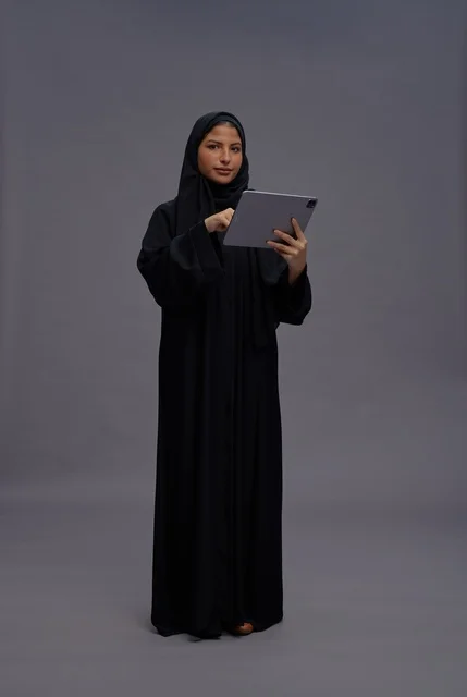 Saudi Woman in Black Abaya Using Tablet Studio Shot