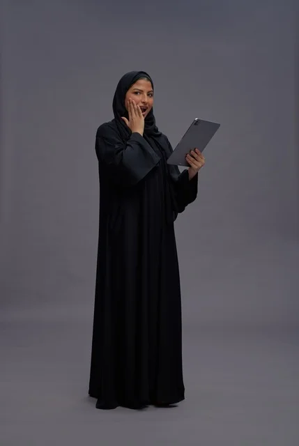 Surprised Saudi Woman Using Digital Tablet in Studio