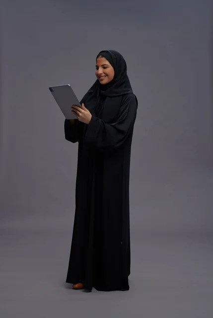 Saudi Woman with Tablet in Studio Setting
