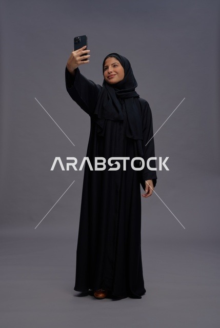 Saudi Woman Selfie with Smartphone in Black Abaya