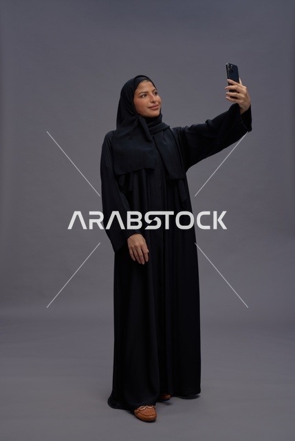 Saudi Woman in Abaya Taking Smartphone Selfie
