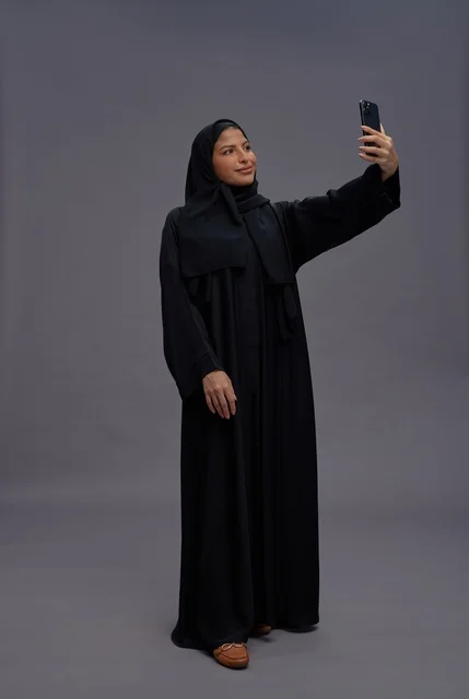 Saudi Woman in Abaya Taking Smartphone Selfie