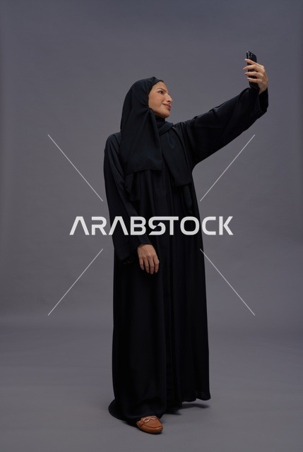 Saudi Woman in Abaya Taking Smartphone Selfie