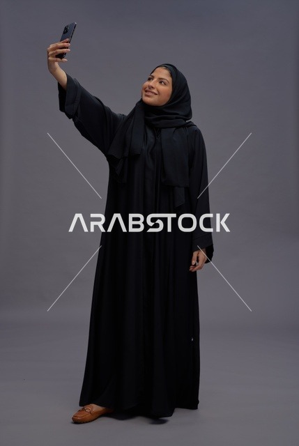 Saudi Woman in Abaya Taking Selfie With Smartphone