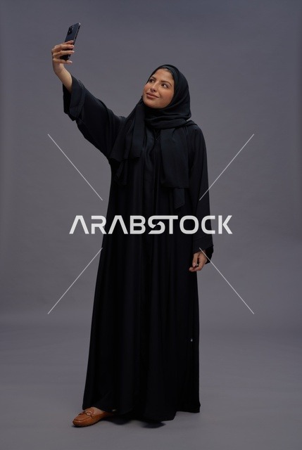 Saudi Woman in Black Abaya Taking Selfie with Smartphone