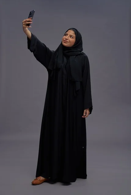 Saudi Woman in Black Abaya Taking Selfie with Smartphone