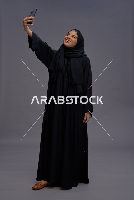 Saudi Woman Taking Selfie in Traditional Abaya