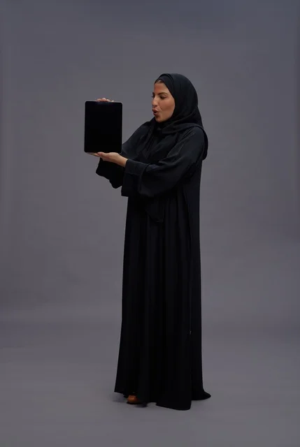 Saudi Woman in Abaya Holding Tablet with Blank Screen