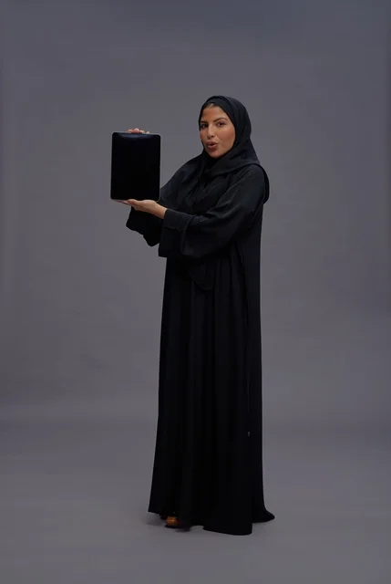 Saudi Woman in Abaya Holding Tablet Blank Screen
