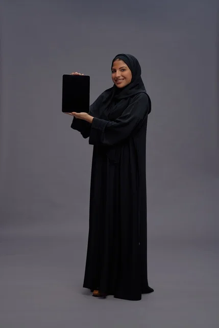 Saudi Woman in Abaya Holding Tablet with Blank Screen