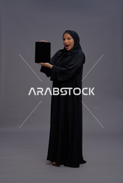 Saudi Woman Holding Tablet with Blank Mockup Screen