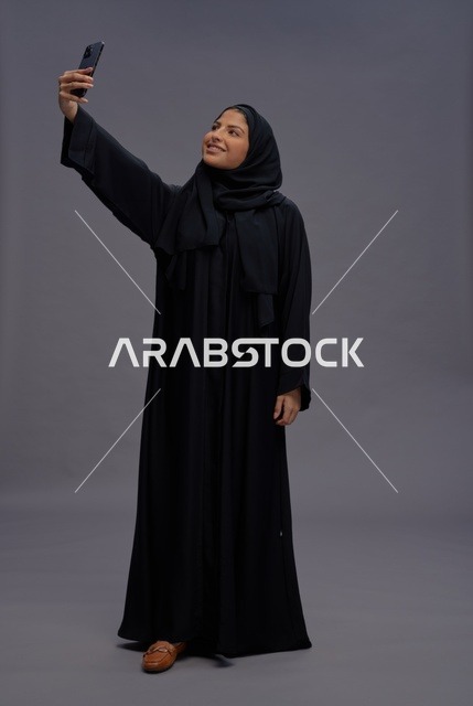 Saudi Woman in Abaya Taking Smartphone Selfie Studio