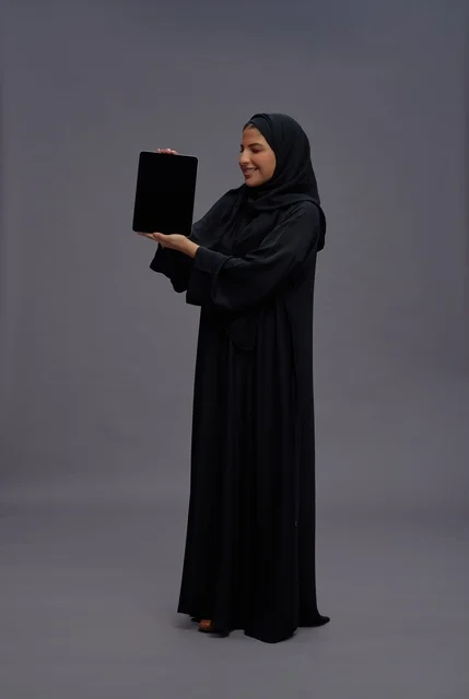Saudi Woman in Abaya Holding Tablet with Blank Screen