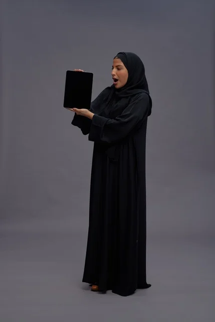 Saudi Woman in Abaya Holding Tablet with Blank Screen