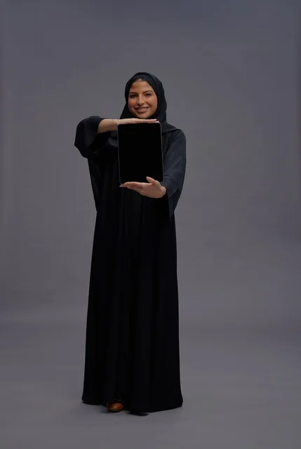 Saudi Woman in Abaya Holding Tablet with Blank Screen