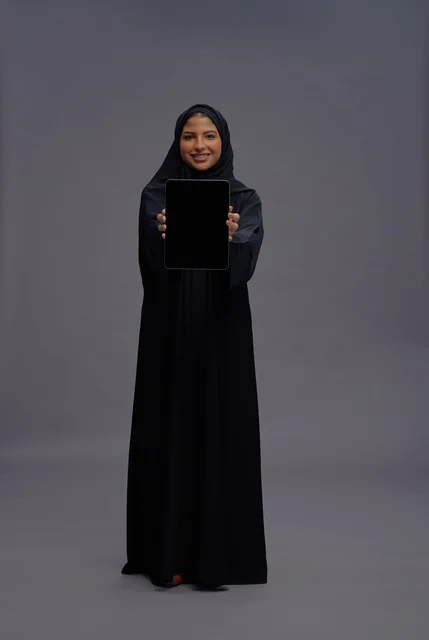 Saudi Woman in Abaya Holding Tablet Blank Screen
