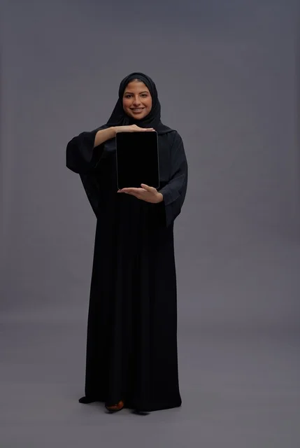 Saudi Woman in Abaya Holding Blank Tablet Screen