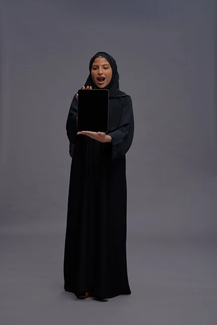 Saudi Woman in Abaya Holding Tablet Blank Screen