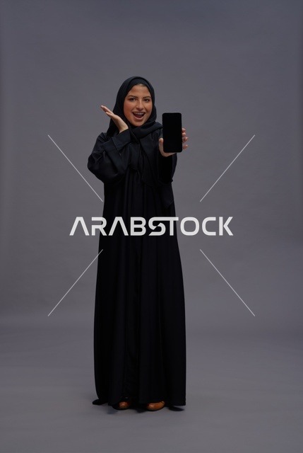 Saudi Woman Holding Blank Smartphone Screen in Abaya