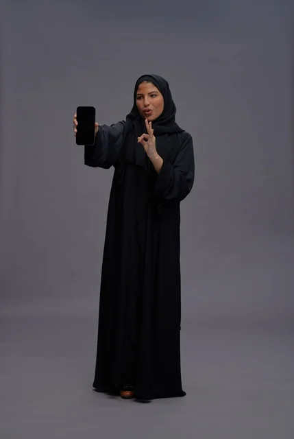 Saudi Woman with Abaya Holding Blank Smartphone Screen