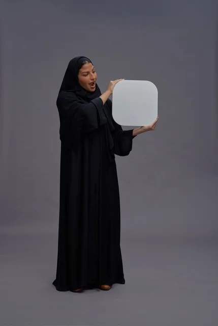 Surprised Saudi Woman Holding Blank White Advertising Board