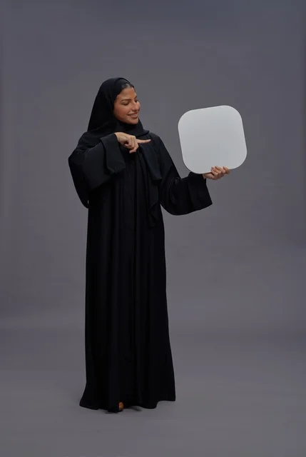 Saudi Woman in Black Abaya Holding Empty White Board