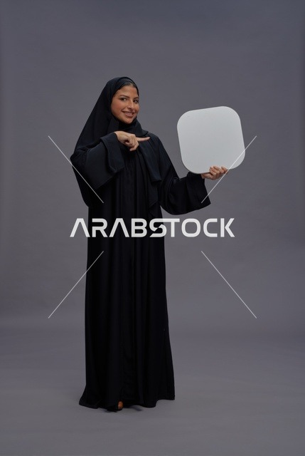 Saudi Woman in Abaya Holding Blank White Board