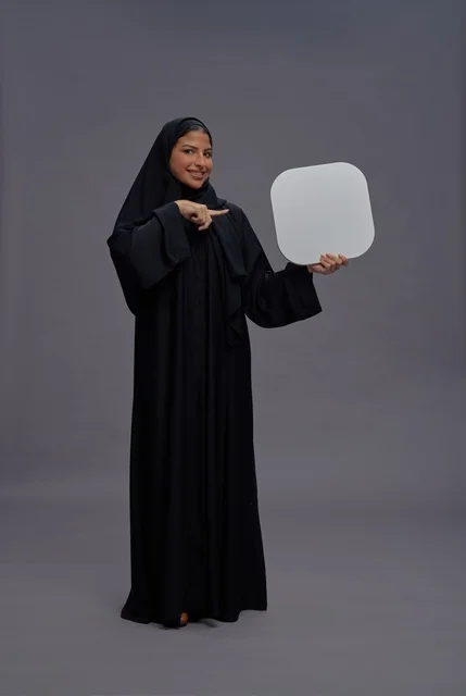 Saudi Woman in Abaya Holding Blank White Board