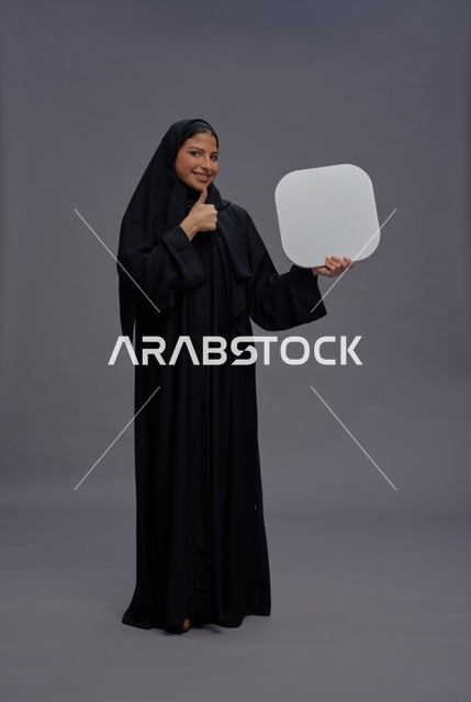 Arab Woman in Abaya Holding Blank Sign With Thumbs Up