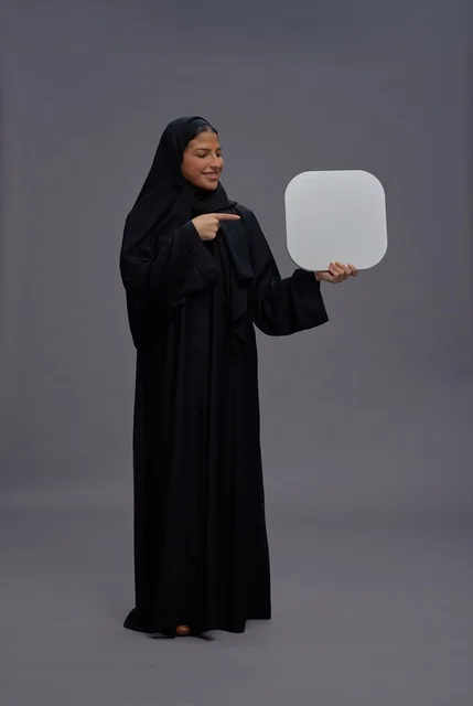 Saudi Woman in Abaya Holding Blank Sign in Studio