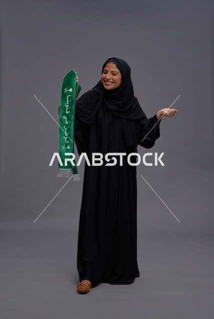 Saudi Woman Holding National Day Flag Studio Portrait