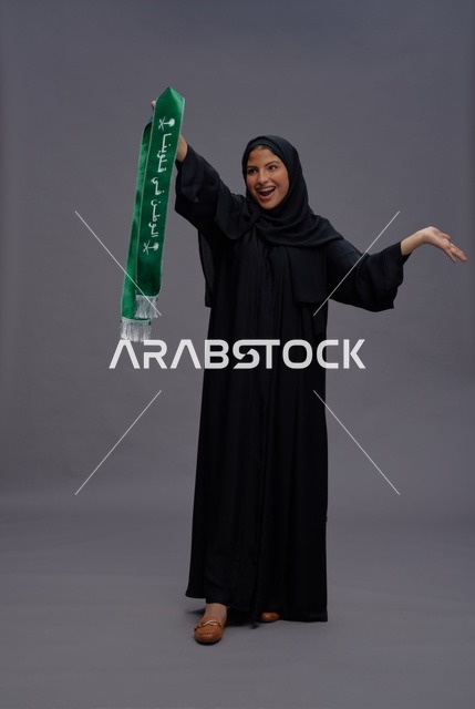 Saudi Woman Holding National Scarf in Studio Portrait