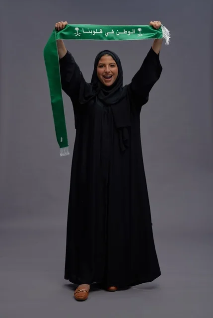 Saudi Woman with National Scarf on Gray Background Saudi Woman with National Scarf on Gray Background
