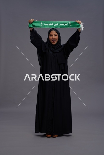 Saudi Woman Holding National Scarf on Gray Background