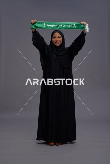 امرأة سعودية تحمل وشاح الوطن في الاستوديو
