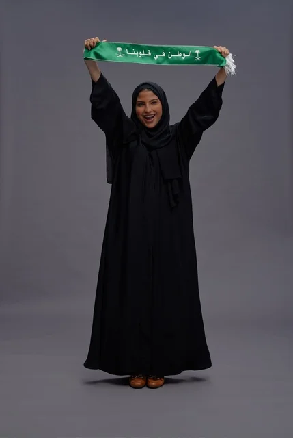 Saudi Woman Holding National Scarf in Celebration