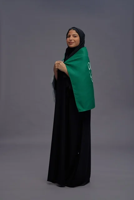 Saudi Woman Wearing National Flag in Studio Portrait