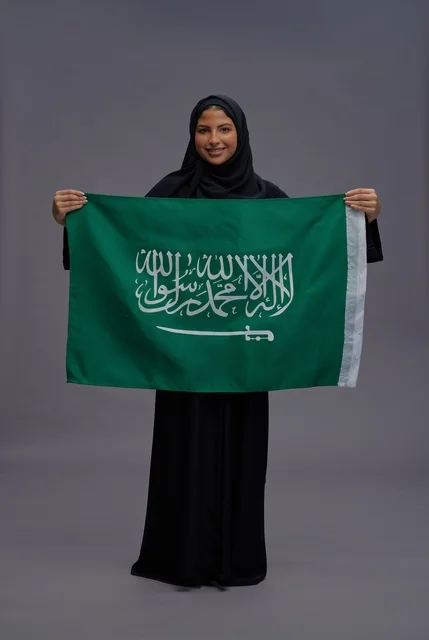 Saudi Woman Holding National Flag in Saudi Arabia